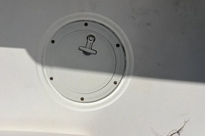 Slide: The Image of 2015 Boston Whaler 270 Dauntless deck hatch with textured surface and shadow. - 38