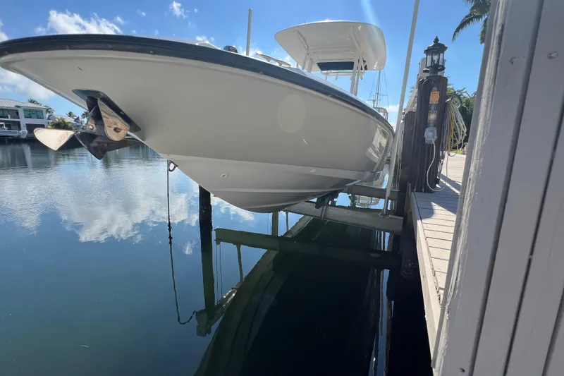 Slide: The Image of 2015 Boston Whaler 270 Dauntless boat docked on a sunny day. - 4