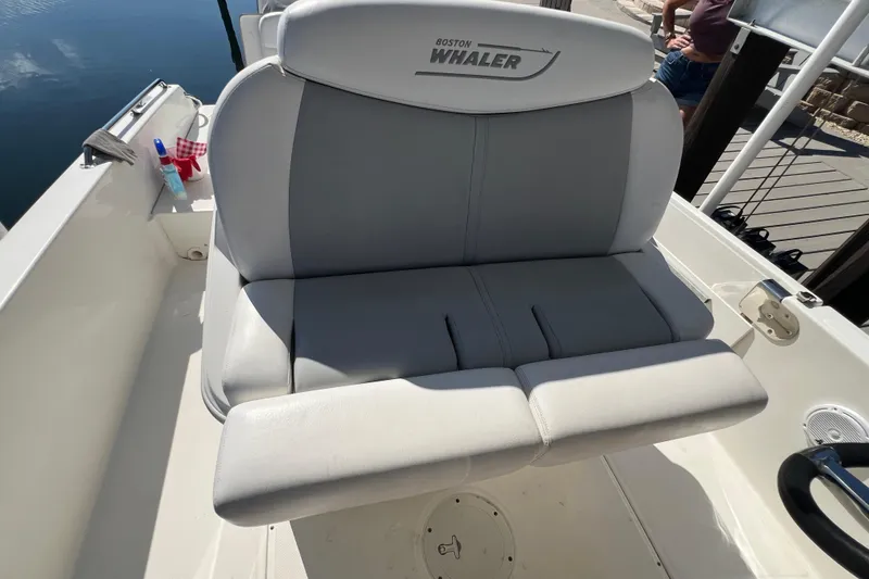 Slide: The Image of Boston Whaler 270 Dauntless 2015 boat seat, gray upholstery, docked by water. - 44