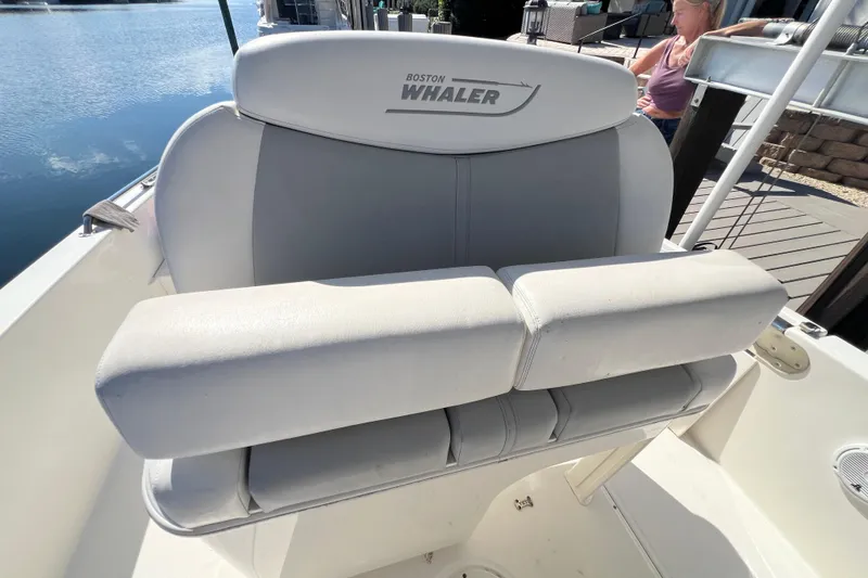 Slide: The Image of 2015 Boston Whaler 270 Dauntless boat seat with logo, dockside view. - 45