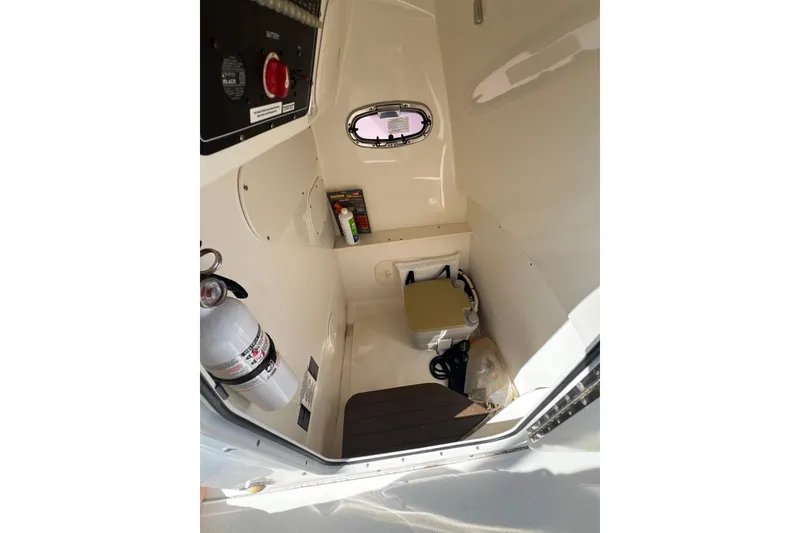 Slide: The Image of 2015 Boston Whaler 270 Dauntless interior cabin with fire extinguisher and storage space. - 48