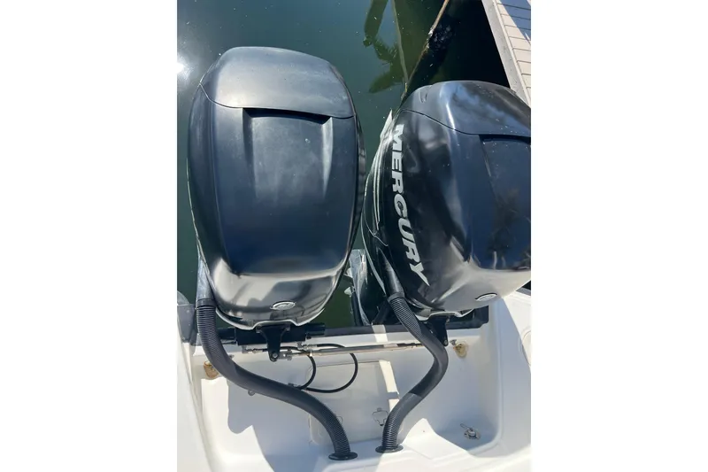 Slide: The Image of Twin Mercury outboard engines on a 2015 Boston Whaler 270 Dauntless boat. - 50