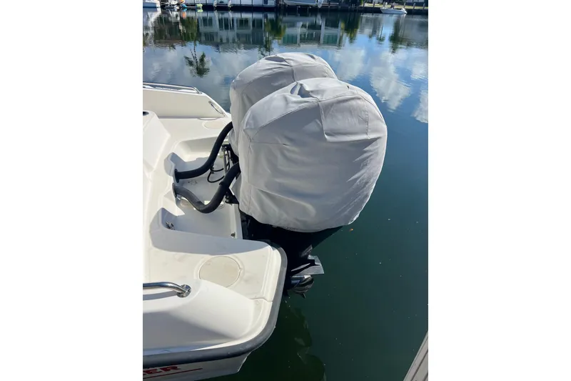 Slide: The Image of Boston Whaler 270 Dauntless 2015 with covered outboard motors on calm water. - 52