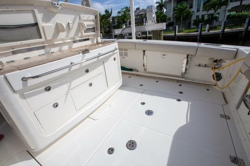 Slide: The Image of 2023 Boston Whaler 380 Outrage boat deck with storage compartments and seating. - 5