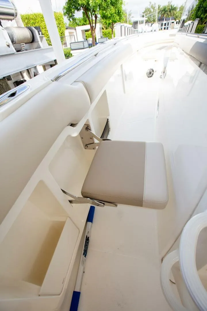 Slide: The Image of 2023 Boston Whaler 380 Outrage interior with foldable seat and sleek design. - 8