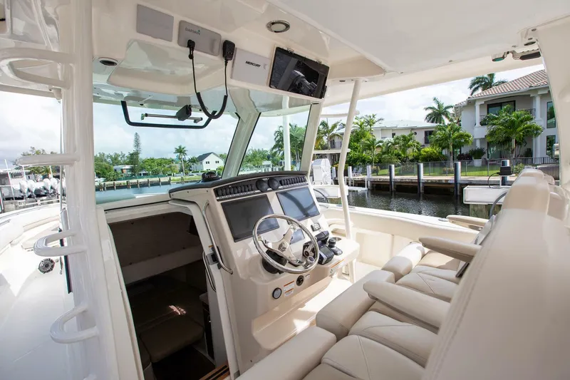Slide: The Image of Interior view of 2023 Boston Whaler 380 Outrage boat, featuring modern helm and seating. - 9