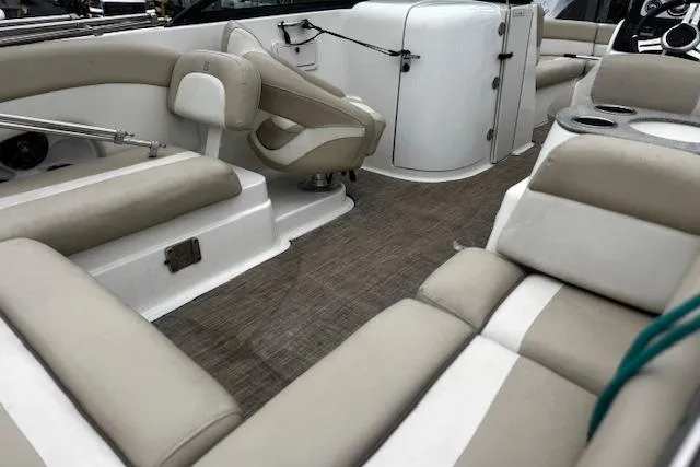 Slide: The Image of 2018 NauticStar 243DC Sport Deck interior with beige seating and modern design. - 13