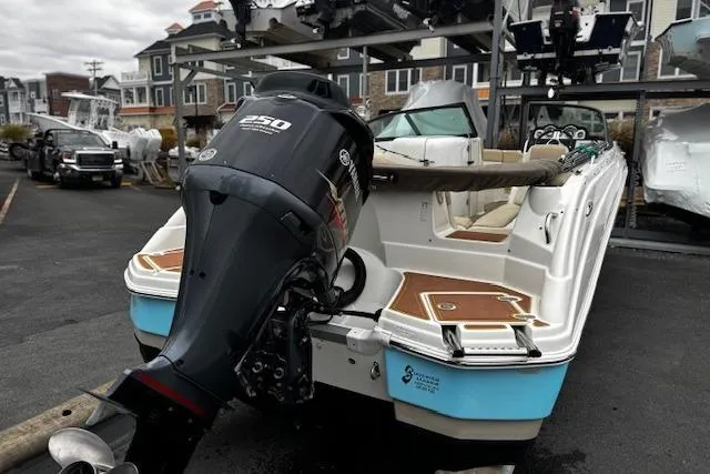 Slide: The Image of 2018 NauticStar 243DC Sport Deck boat with Yamaha 250 engine, parked in marina. - 14