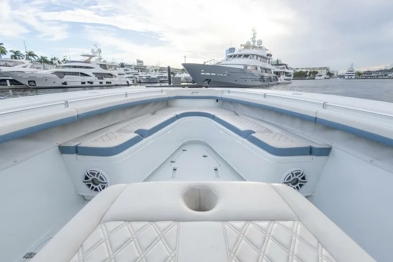 Slide: The Image of 2023 Yellowfin 42 Offshore boat interior with luxurious seating at marina. - 28
