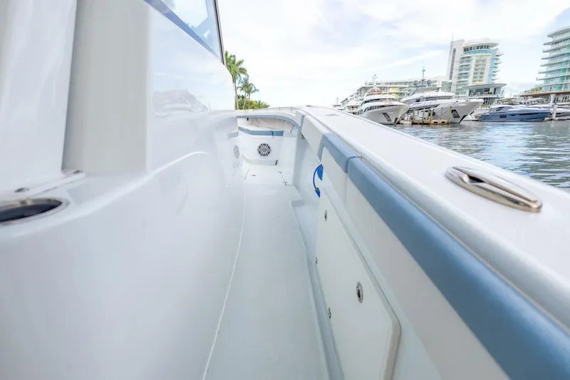 Slide: The Image of 2023 Yellowfin 42 Offshore boat docked at marina, showcasing sleek design and spacious deck. - 35