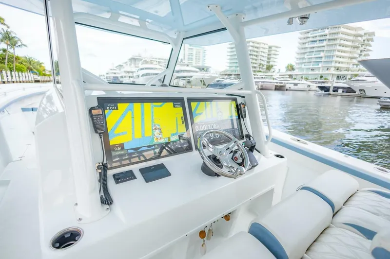 Slide: The Image of 2023 Yellowfin 42 Offshore boat cockpit with navigation screens and steering wheel. - 42