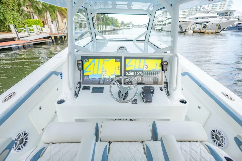 Slide: The Image of 2023 Yellowfin 42 Offshore boat cockpit with advanced navigation system and luxurious seating. - 43