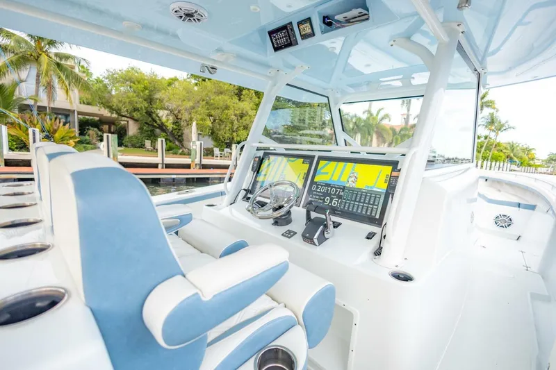Slide: The Image of 2023 Yellowfin 42 Offshore boat interior with advanced navigation system and plush seating. - 45