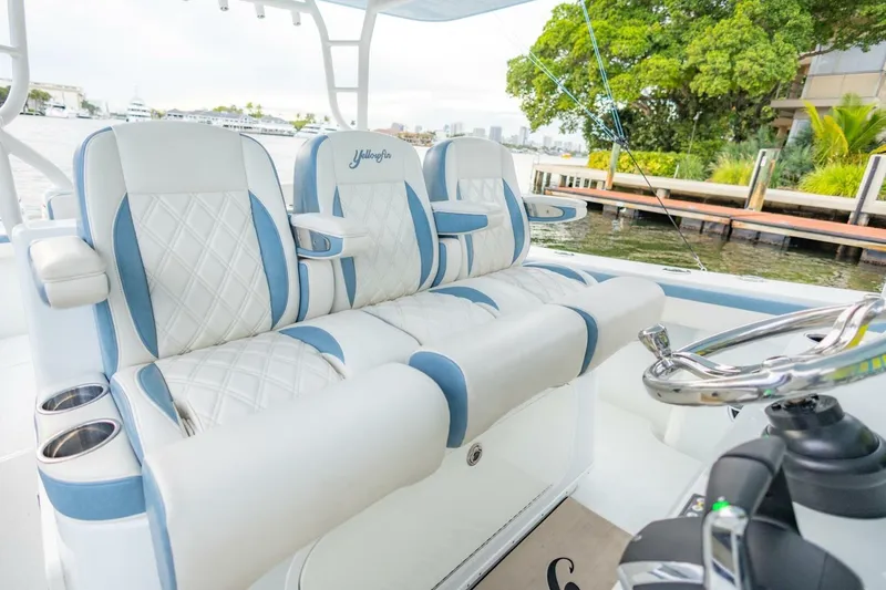 Slide: The Image of Luxurious seating on 2023 Yellowfin 42 Offshore boat, featuring elegant white and blue upholstery. - 46