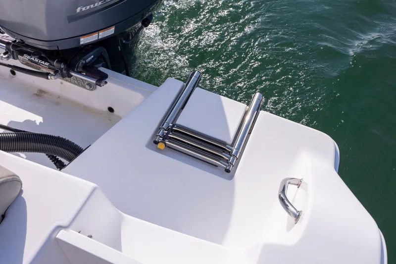 Slide: The Image of 2022 Sportsman Open 212 Center Console boat with folded ladder and motor. - 11