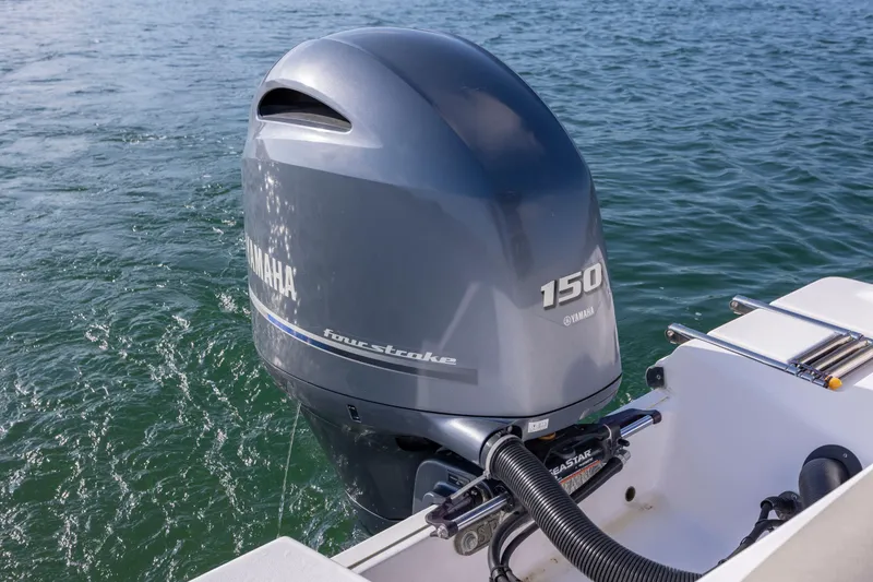 Slide: The Image of 2022 Sportsman Open 212 Center Console with Yamaha 150 outboard engine on water. - 13