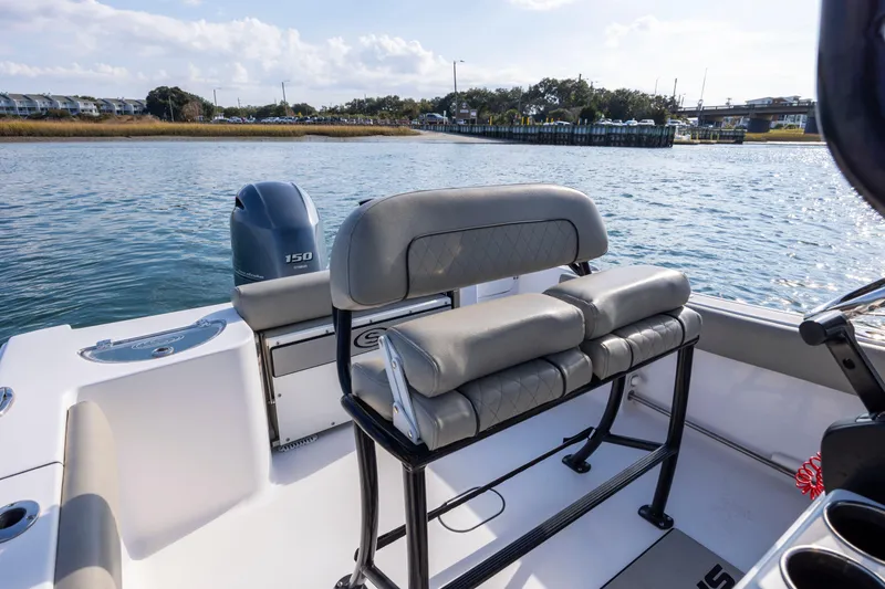Slide: The Image of 2022 Sportsman Open 212 Center Console boat interior with seating and Yamaha 150 engine. - 19
