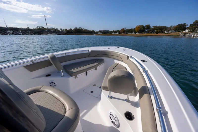 Slide: The Image of 2022 Sportsman Open 212 Center Console boat on calm water, featuring comfortable seating. - 20