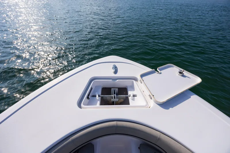 Slide: The Image of 2022 Sportsman Open 212 Center Console boat on water, open anchor hatch. - 24