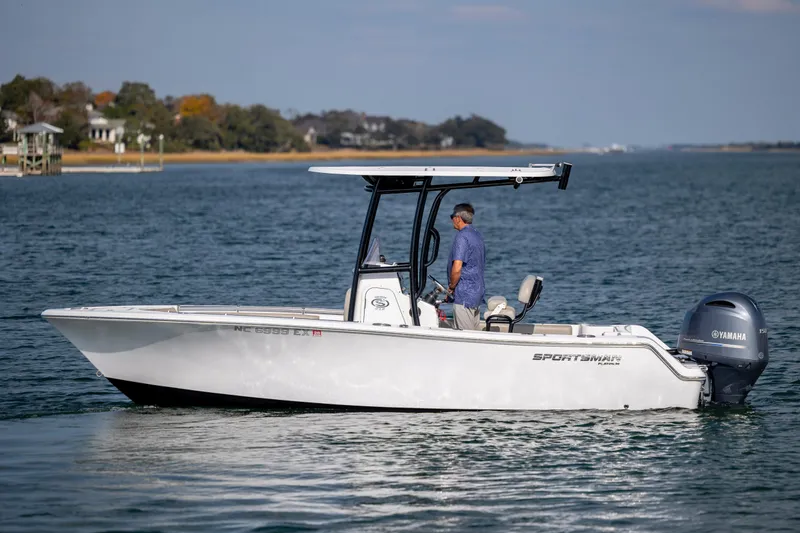 Slide: The Image of 2022 Sportsman Open 212 Center Console boat on calm water with Yamaha engine. - 6