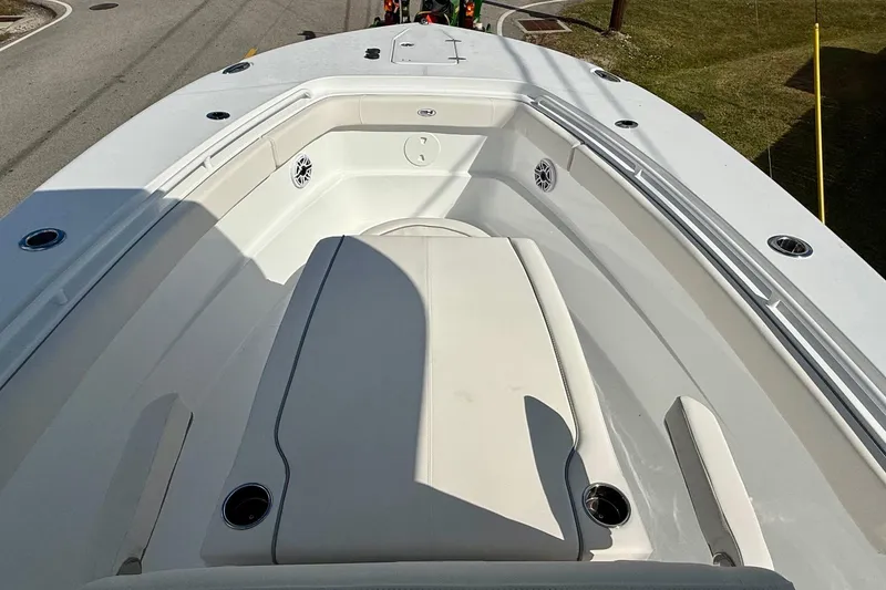 Slide: The Image of 2026 Sea Hunt Ultra 285 Coffin Box boat interior with seating and cup holders. - 14
