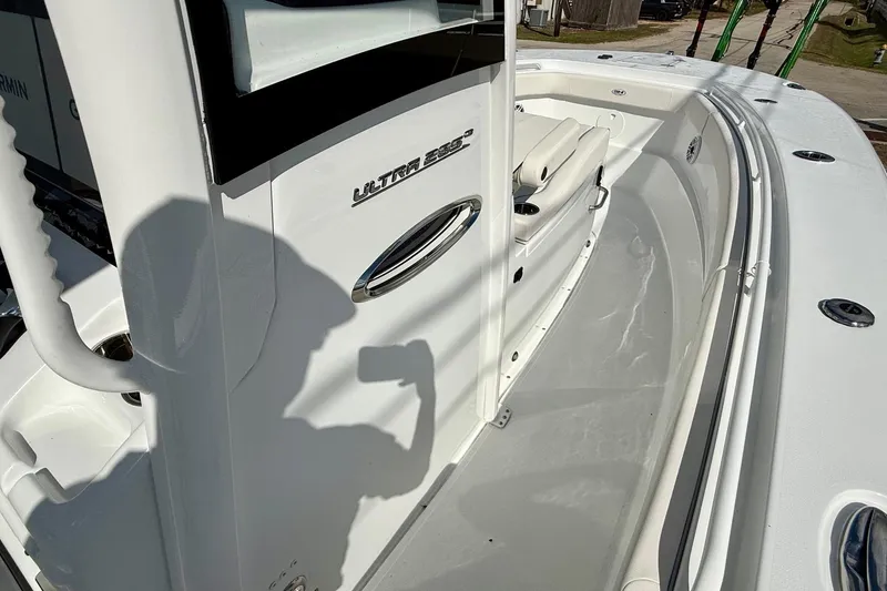 Slide: The Image of 2026 Sea Hunt Ultra 285 Coffin Box boat deck with seating and console. - 15