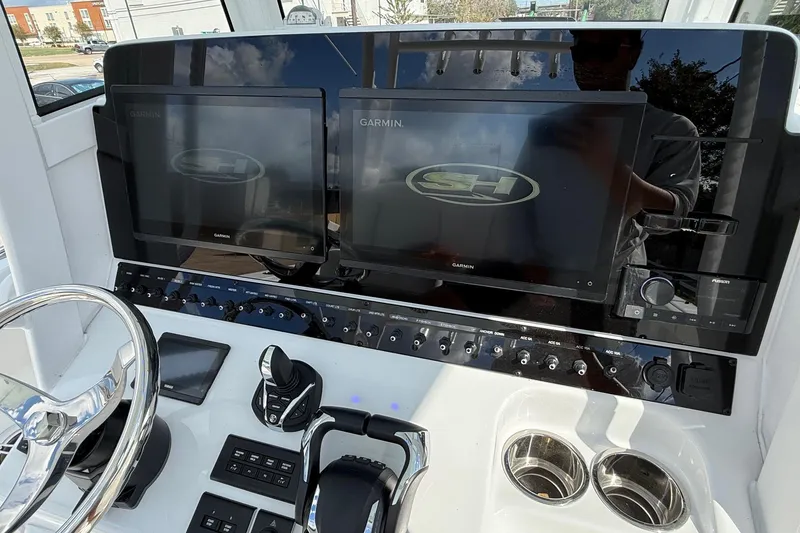 Slide: The Image of Control panel of 2026 Sea Hunt Ultra 285 Coffin Box with dual Garmin displays. - 17