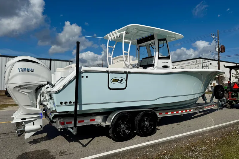 Slide: The Image of 2026 Sea Hunt Ultra 285 Coffin Box boat on trailer, featuring Yamaha engines. - 4