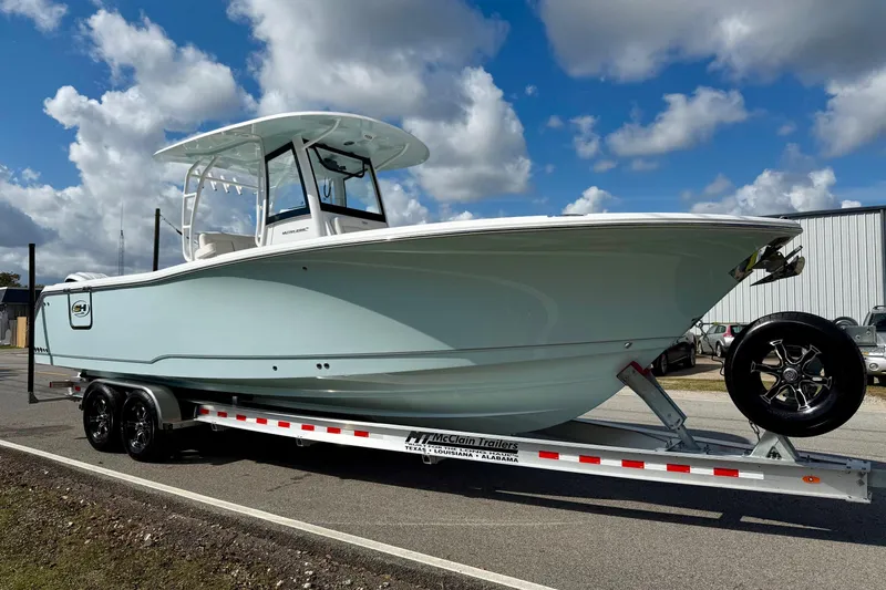 Slide: The Image of 2026 Sea Hunt Ultra 285 Coffin Box boat on trailer under a cloudy sky. - 5