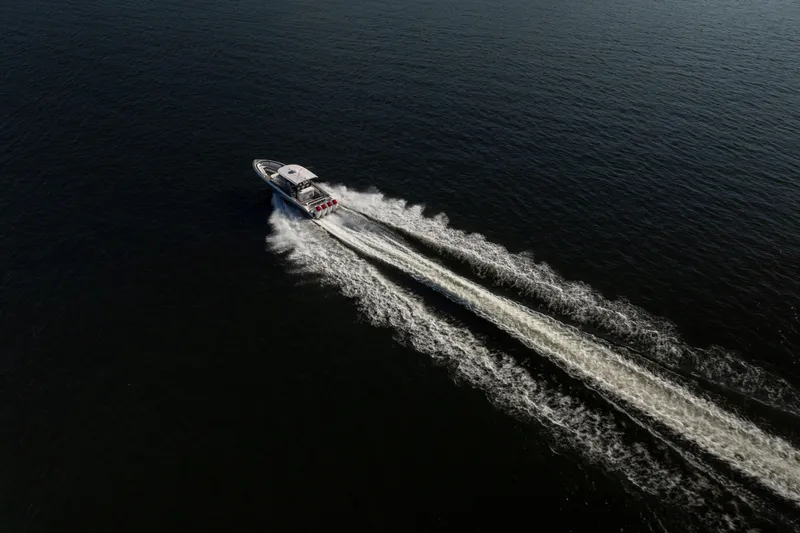 Slide: The Image of Aerial view of 2020 Fountain 43 NX speedboat cruising on open water. - 10