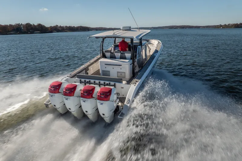 Slide: The Image of 2020 Fountain 43 NX boat with four engines cruising on a lake. - 11