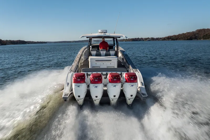 Slide: The Image of 2020 Fountain 43 NX boat with four powerful outboard engines cruising on a lake. - 12