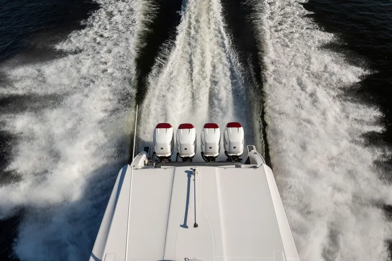 Slide: The Image of 2020 Fountain 43 NX boat with four engines creating wake on water. - 15