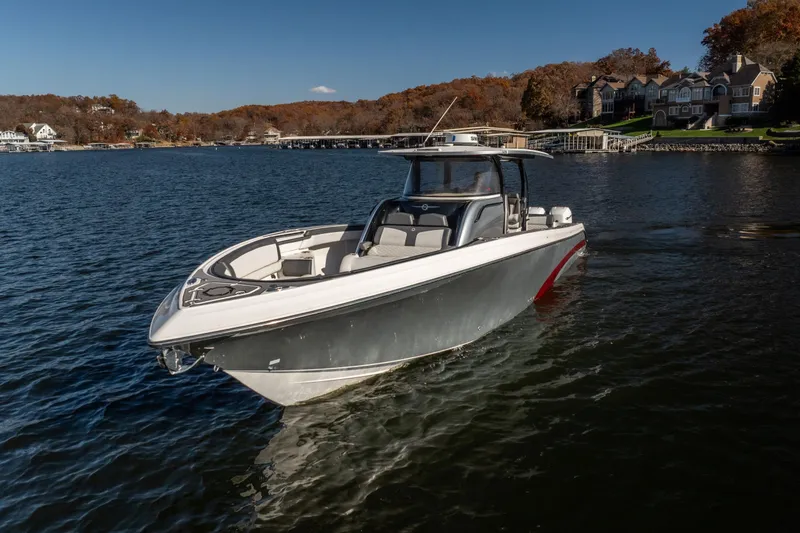 Slide: The Image of 2020 Fountain 43 NX boat on a serene lake with autumn foliage background. - 17