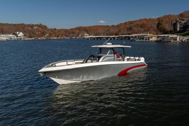 Slide: The Image of 2020 Fountain 43 NX boat cruising on a scenic lake with autumn foliage. - 18