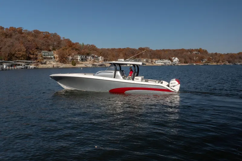 Slide: The Image of 2020 Fountain 43 NX boat cruising on a lake with autumn foliage background. - 19