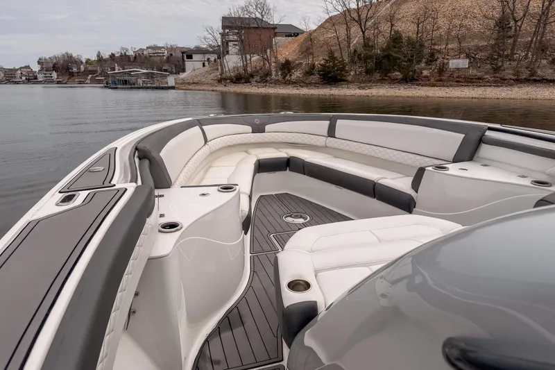 Slide: The Image of 2020 Fountain 43 NX boat interior with luxurious seating on a calm lake. - 23