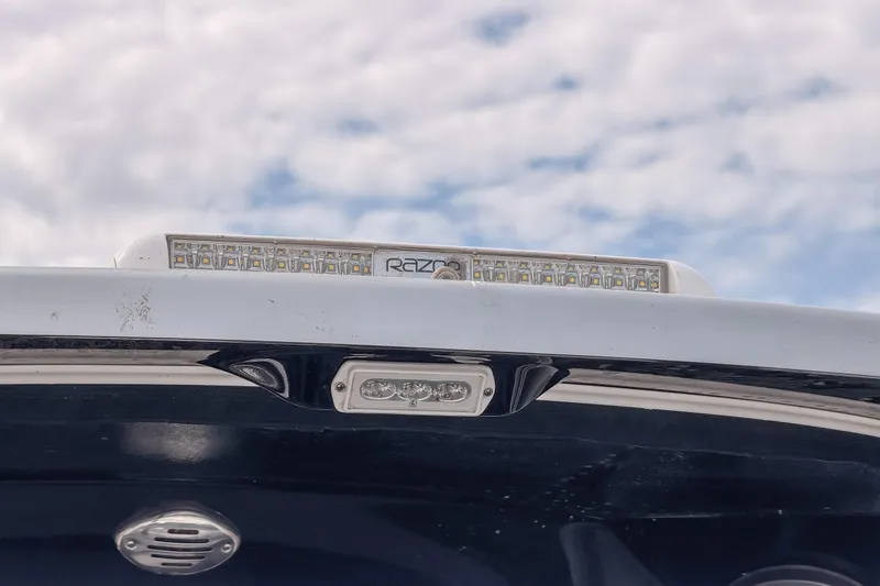 Slide: The Image of 2020 Fountain 43 NX boat with LED lights against a cloudy sky backdrop. - 30