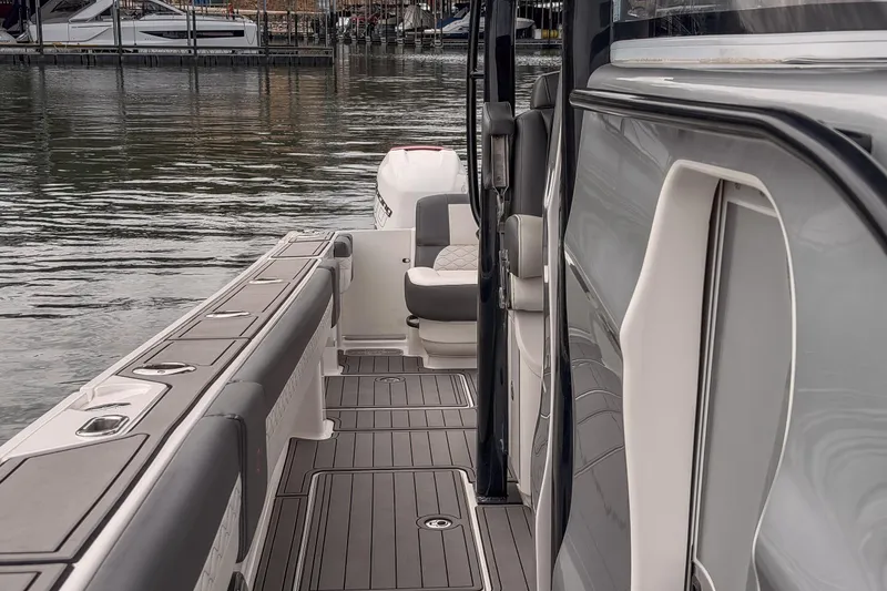 Slide: The Image of 2020 Fountain 43 NX boat deck with seating, docked by the water. - 31