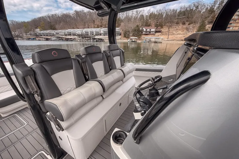Slide: The Image of 2020 Fountain 43 NX boat interior with luxurious seating and modern helm, dockside view. - 34