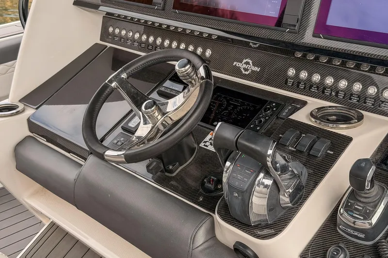 Slide: The Image of 2020 Fountain 43 NX boat dashboard with steering wheel and control panel. - 36