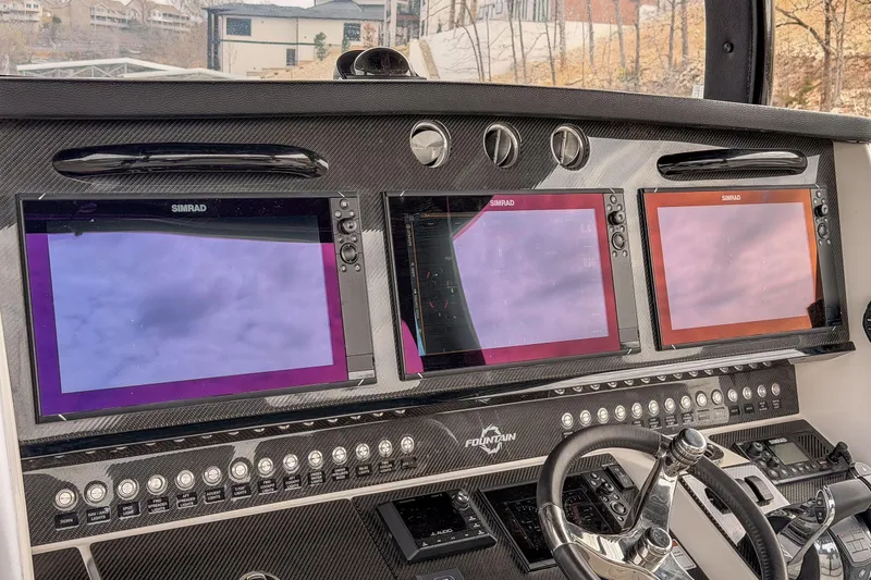 Slide: The Image of Dashboard of 2020 Fountain 43 NX boat with three Simrad displays and controls. - 40