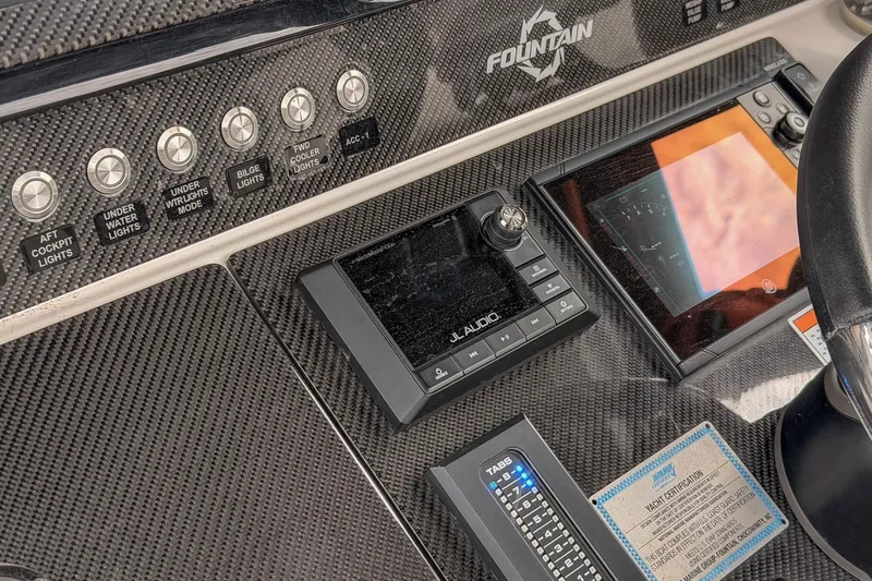 Slide: The Image of Dashboard of a 2020 Fountain 43 NX boat with control panels and navigation screens. - 41