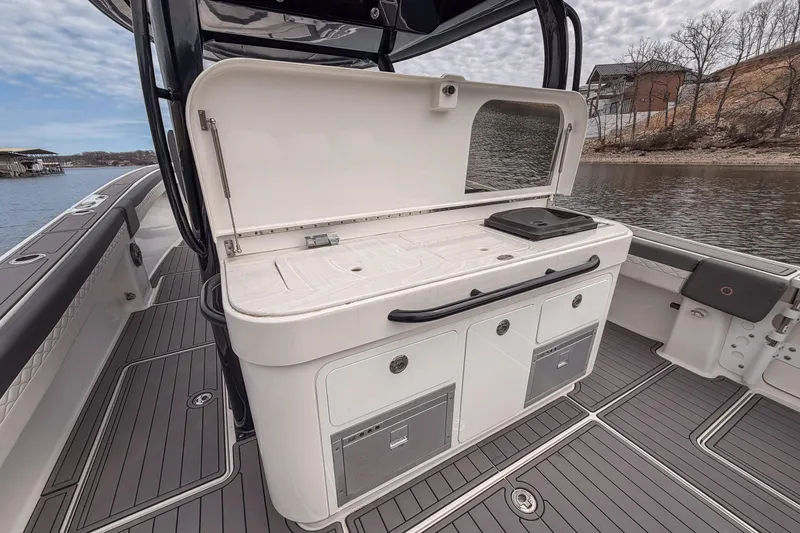Slide: The Image of 2020 Fountain 43 NX boat interior with open storage and sleek design by the water. - 45