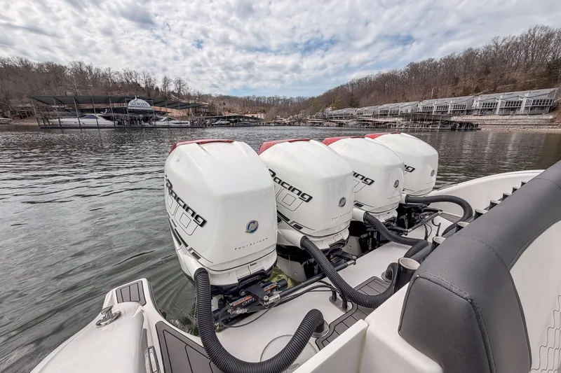 Slide: The Image of 2020 Fountain 43 NX boat with triple outboard engines on a calm lake. - 47