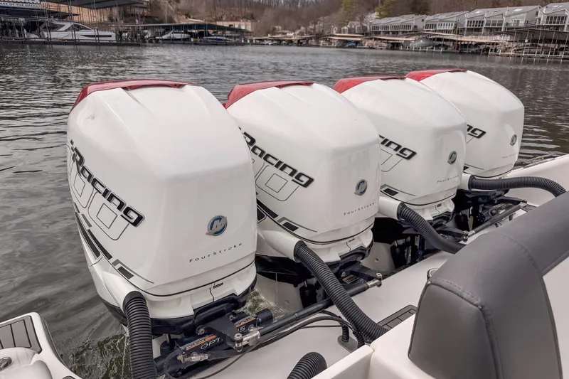 Slide: The Image of Four powerful outboard engines on a 2020 Fountain 43 NX boat, docked by the waterfront. - 48