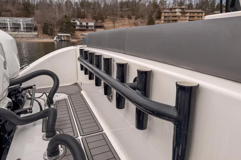 Slide: The Image of 2020 Fountain 43 NX boat interior with rod holders and engine details. - 49