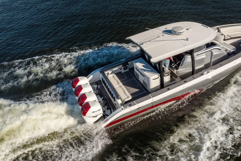 Slide: The Image of 2020 Fountain 43 NX boat cruising on water with powerful outboard engines. - 7