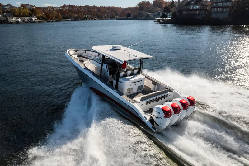 Slide: The Image of 2020 Fountain 43 NX boat cruising on a scenic lake with powerful engines. - 9