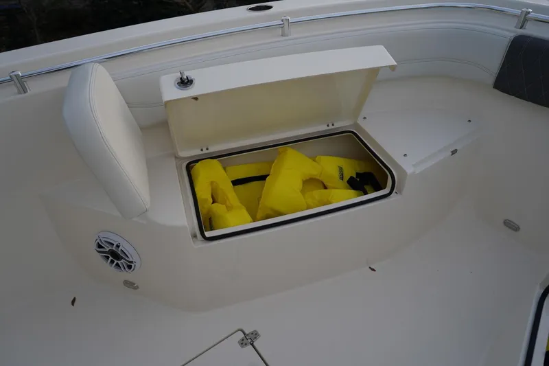 Slide: The Image of 2022 Cobia 266 boat storage compartment with yellow life jackets. - 17